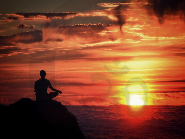 Meditation - Mindfulness - Person Meditating at Sunset Over the Clouds